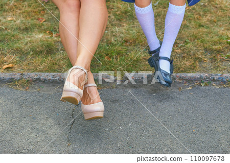 Women's problems. Tired legs, feet, heels. Legs of mother and daughter 110097678