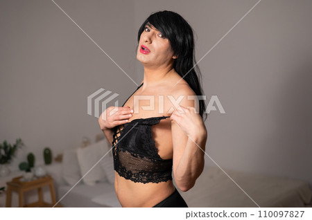 Gay man in wig and black lace lingerie.  110097827