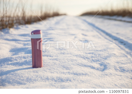 Winter feminine thermal mug on a fuzzy background. 110097831