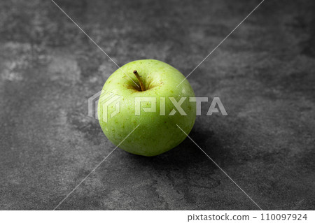 green apple on a black background green apple on a black background 110097924