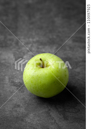 green apple on a black background green apple on a black background 110097925