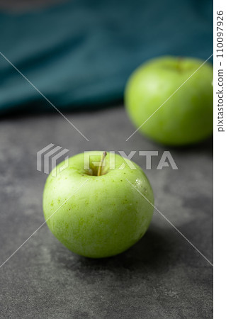 green apple on a black background green apple on a black background 110097926