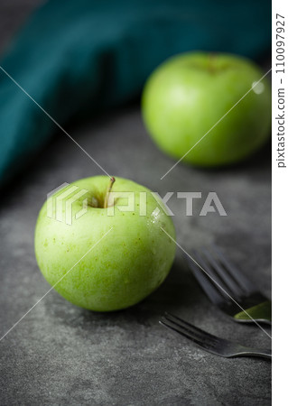 green apple on a black background 110097927