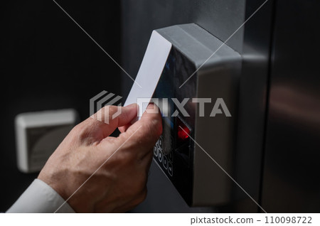 A man opens the door with a card. Modern electronic lock. Keyless Entry 110098722
