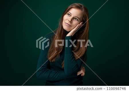 30 year old pretty European woman hopes for good and dreams on a dark background 110098746