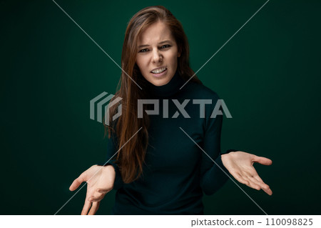 Headshot portrait of a woman with brown natural hair with confusion on her face 110098825