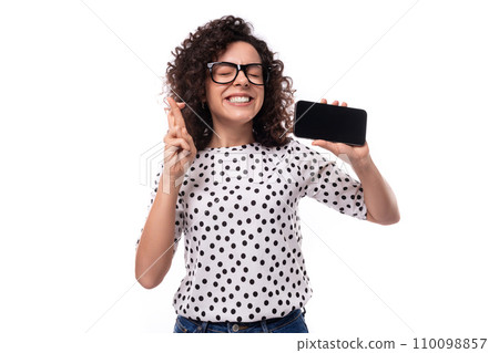 young leader woman with curly hairstyle dressed in summer blouse hopes to win online holding 110098857
