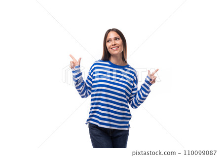 young caucasian woman with dark hair dressed in a blue striped sweatshirt points her hand to the 110099087