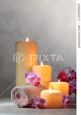 Towels, orchid flowers, and burning candles. Towels, orchid flowers, and burning candles. 110099664