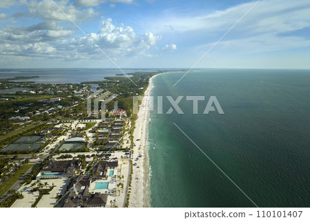 Premium housing development in the USA. Expensive waterfront houses between green palm trees in Boca Grande, small town on Gasparilla Island in southwest Florida 110101407