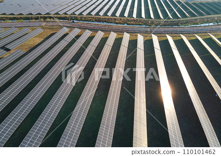 Aerial view of large sustainable electrical power plant with rows of solar photovoltaic panels for producing clean ecological electric energy. Renewable electricity with zero emission concept 110101462