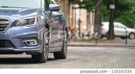 Close up of a car parked on city street side 110101539