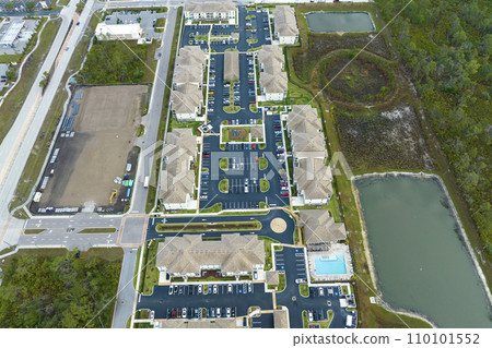 Aerial view of american apartment buildings in Florida residential area. New family condos as example of housing development in US suburbs 110101552