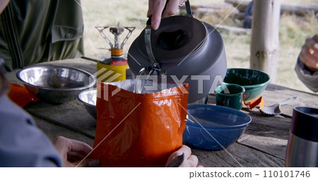 Close up of Caucasian woman taking kettle from gas burner Close up of Caucasian woman taking kettle from gas burner 110101746