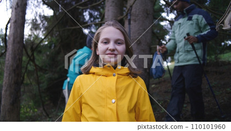 Happy Caucasian woman looks at camera during trekking trip in mountains 110101960