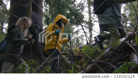 Group of hiking buddies during trip or expedition in mountains 110102124