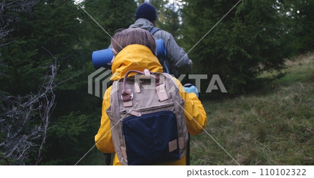 Caucasian tourist family during hike or trek in mountains Caucasian tourist family during hike or trek in mountains 110102322