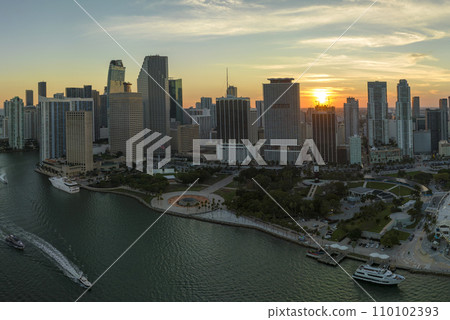 Aerial view of downtown district of of Miami Brickell in Florida, USA at sunset. High commercial and residential skyscraper buildings in modern american megapolis Aerial view of downtown district of of Miami Brickell in Florida, USA at sunset. High commercial and residential skyscraper buildings in modern american megapolis 110102393