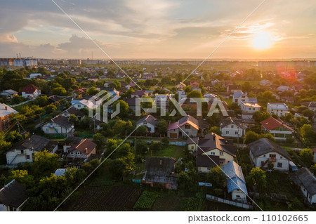Aerial view of residential houses in suburban rural area at sunset 110102665