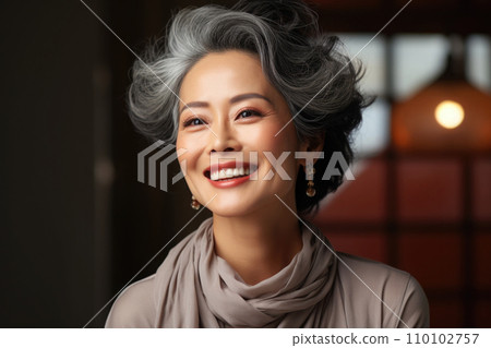 Smiling middle aged asian woman looking at camera 110102757