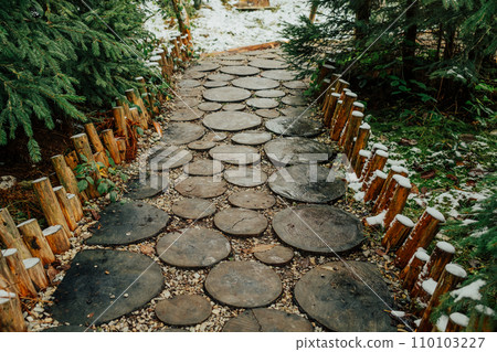 Creative idea for garden paths made of wood, log cabin. Winter nature. 110103227