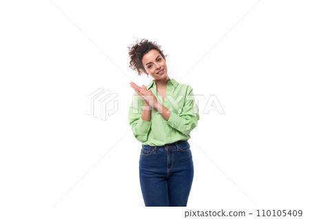 a pretty young slender female model is dressed in a loose fit light green shirt on a white 110105409