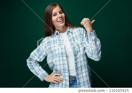 Portrait of an attractive young woman with brown hair on a green background with copy space Portrait of an attractive young woman with brown hair on a green background with copy space 110105425