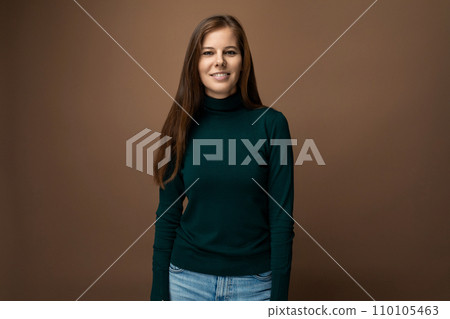 Portrait of a young European woman with brown hair on a brown background with copy space Portrait of a young European woman with brown hair on a brown background with copy space 110105463