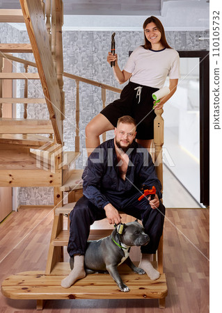 Young spouses with working tools in their hands are preparing to renovate their home. Young spouses with working tools in their hands are preparing to renovate their home. 110105732