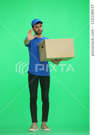 A man on a green background with box. In profile A man on a green background with box. In profile 110106637