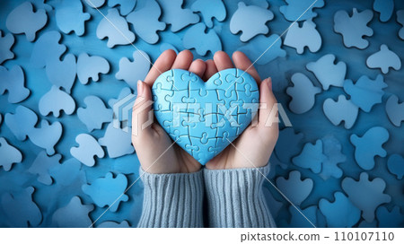 Hands holding blue heart puzzle against blue backdrop of scattered puzzle pieces. World heart day Hands holding blue heart puzzle against blue backdrop of scattered puzzle pieces. World heart day 110107110