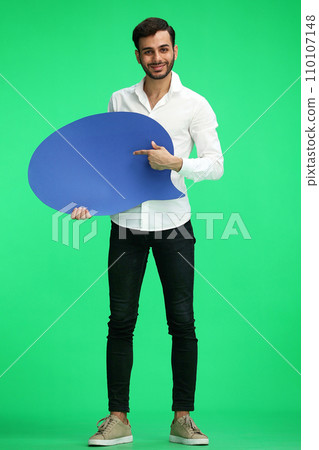 full-length man on a green background holding a sign comment full-length man on a green background holding a sign comment 110107148