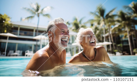 Senior Summer Fun, A silver-haired couple showcases the vibrant energy of seasoned love, splashing in a resort pool, their vivacious spirit undimmed by the passage of time Senior Summer Fun, A silver-haired couple showcases the vibrant energy of seasoned love, splashing in a resort pool, their vivacious spirit undimmed by the passage of time 110107151