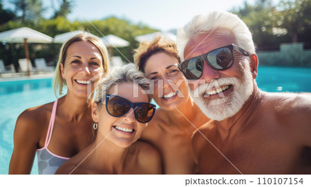 Cheerful senior friends making poolside selfie, camaraderie and cheerful attire speaking volumes of their zest for life and enduring friendships, Zest for Life, essence of a carefree holiday 110107154