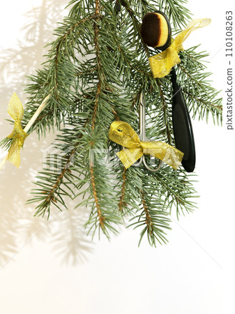 Mockup Manicure or Pedicure Christmas Tree with Tired Scissors, Brush, Wooden Nail Cuticle Stick Remover, Golden Ribbon. Vertical. Christmas and New Year Holidays Concept. Vertical  110108263