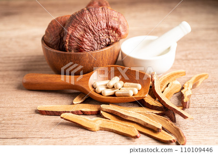 Dried lingzhi mushroom with capsule drug, alternative medicine herbal organic herb. Dried lingzhi mushroom with capsule drug, alternative medicine herbal organic herb. 110109446