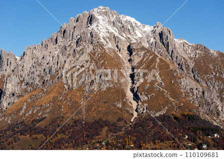Beautiful landscape of the layered misty hazy Italian Alps mountain range during evening. Lombardy, Italy 110109681