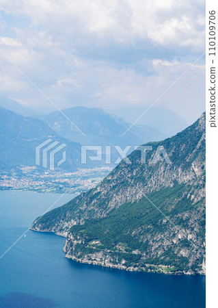 Mountain landscape, picturesque mountain lake in the summer morning, large panorama. Iseo, Italy 110109706