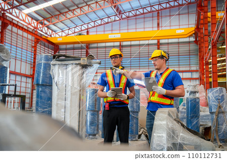Two factory workers or technician hold tablet check and maintenance the machine in factory workplace. Two factory workers or technician hold tablet check and maintenance the machine in factory workplace. 110112731