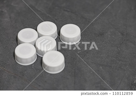 plastic bottle cap on the desk plastic bottle cap on the desk 110112859
