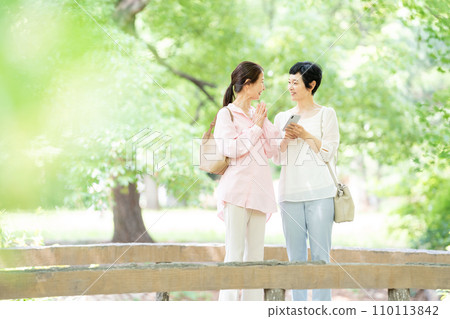 中年婦女用智能手機拍紀念照 中年婦女用智能手機拍紀念照 110113842