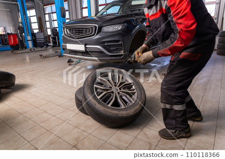 Working inside tire service center. Working inside tire service center. 110118366