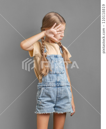 A little girl shows a sign of protest with her hand A little girl shows a sign of protest with her hand 110118819
