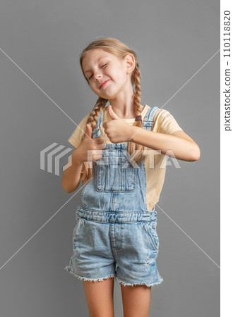 A little  girl shows the ok sign with her hand 110118820