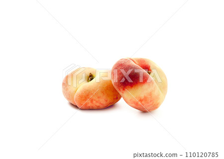 Two saturn peaches or flat peaches isolated on white background with clipping path.. Two saturn peaches or flat peaches isolated on white background with clipping path.. 110120785