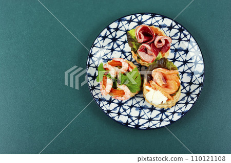 Tartlets with seafood and bacon, tasty snack. 110121108