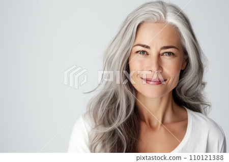 Beautiful senior woman with smooth healthy face skin and grey long hair. Gorgeous aging mature woman happy smiling on white background. Beauty and cosmetics skincare advertising concept 110121388