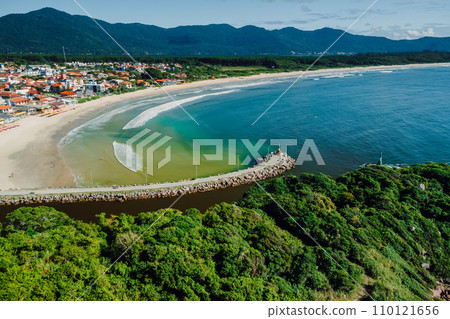 Beach with river and ocean in Brazil. Aerial view of Barra da lagoa village in Florianopolis Beach with river and ocean in Brazil. Aerial view of Barra da lagoa village in Florianopolis 110121656
