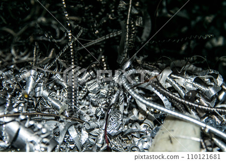 Scrap Closeup twisted spiral steel shavings twisted metal from lathe machine In industrial plants 110121681