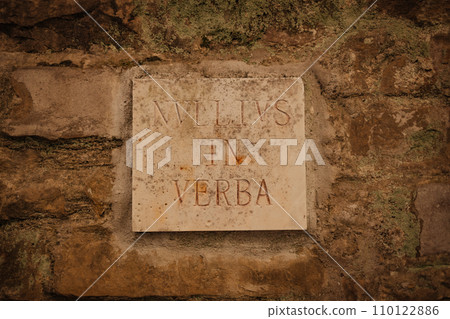 Old plaster brick wall texture with sign board with vintage latin text inscription background, brick wall texture Old plaster brick wall texture with sign board with vintage latin text inscription background, brick wall texture 110122886